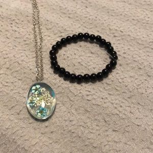 Black bracelet and flower necklace